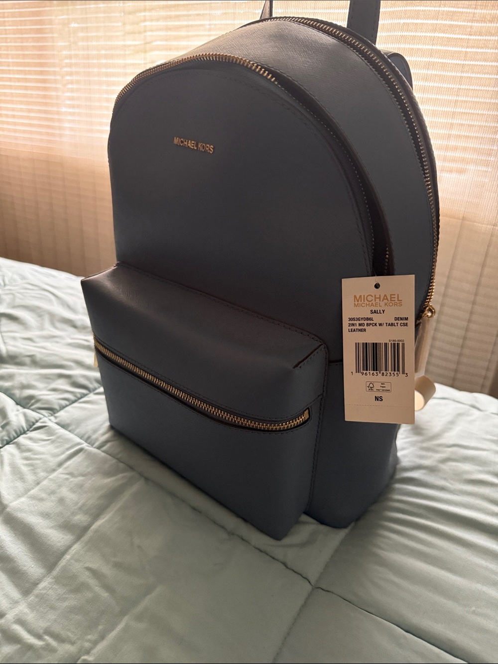 Michael Kors Denim Blue Leather Backpack with Gold Hardware and 3 zip pockets.